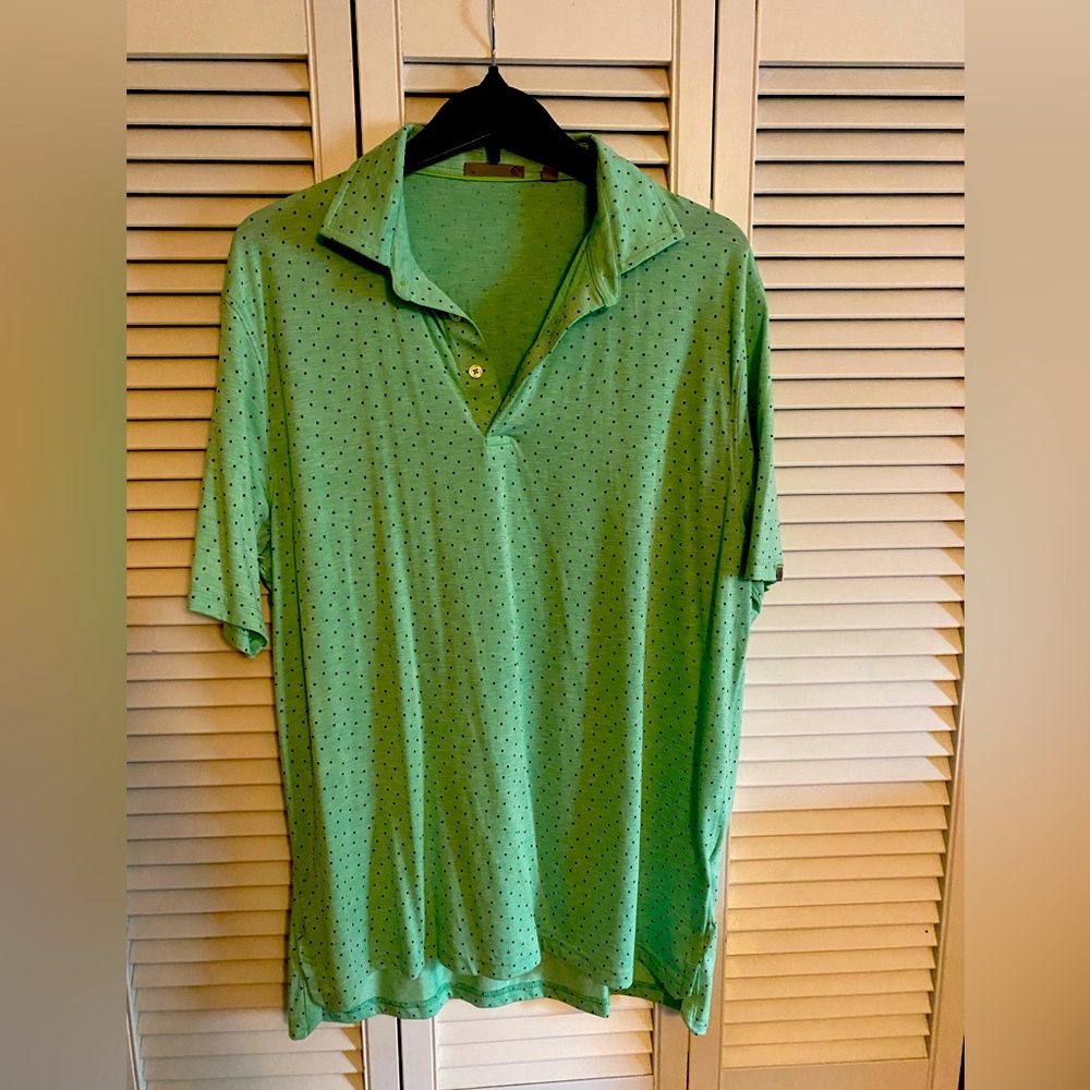 Green polo with blue polka dots in perfect condition.